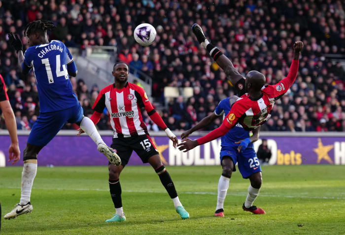 Yoane Wissa pictured (right) in mid-air shooting with a bicycle kick to score a stunning goal for Brentford in a 2-2 draw against Chelsea in March 2024